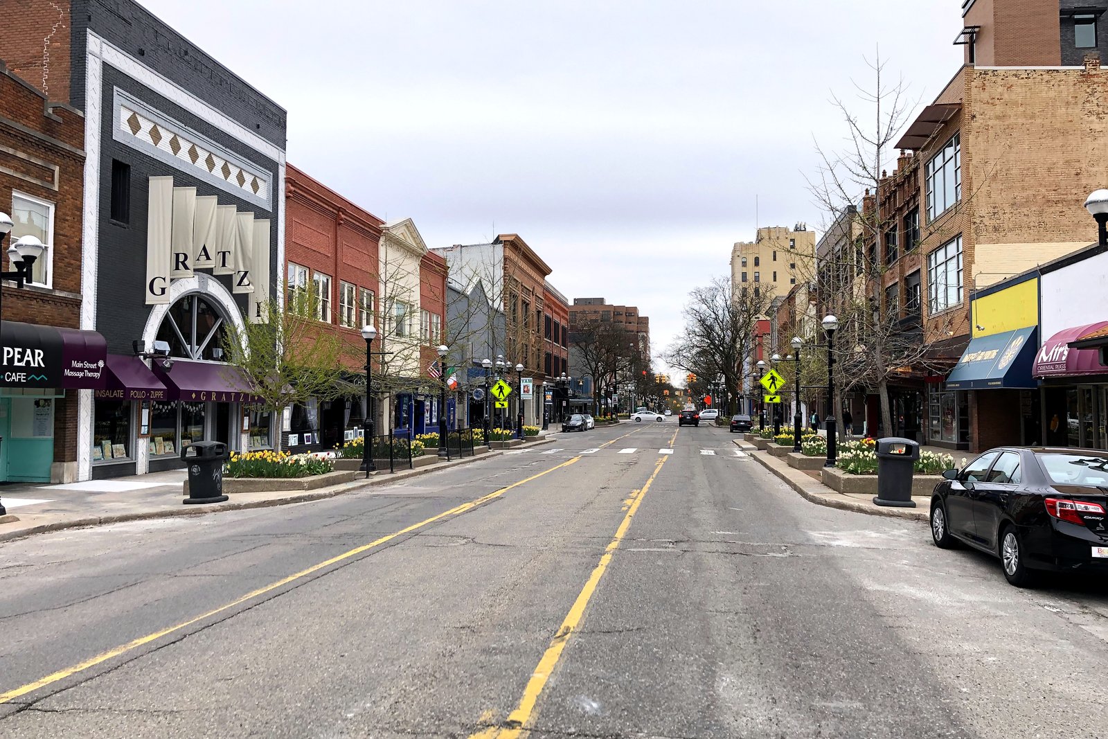 Downtown Ann Arbor street with brick buildings and storefronts, in a file photo.