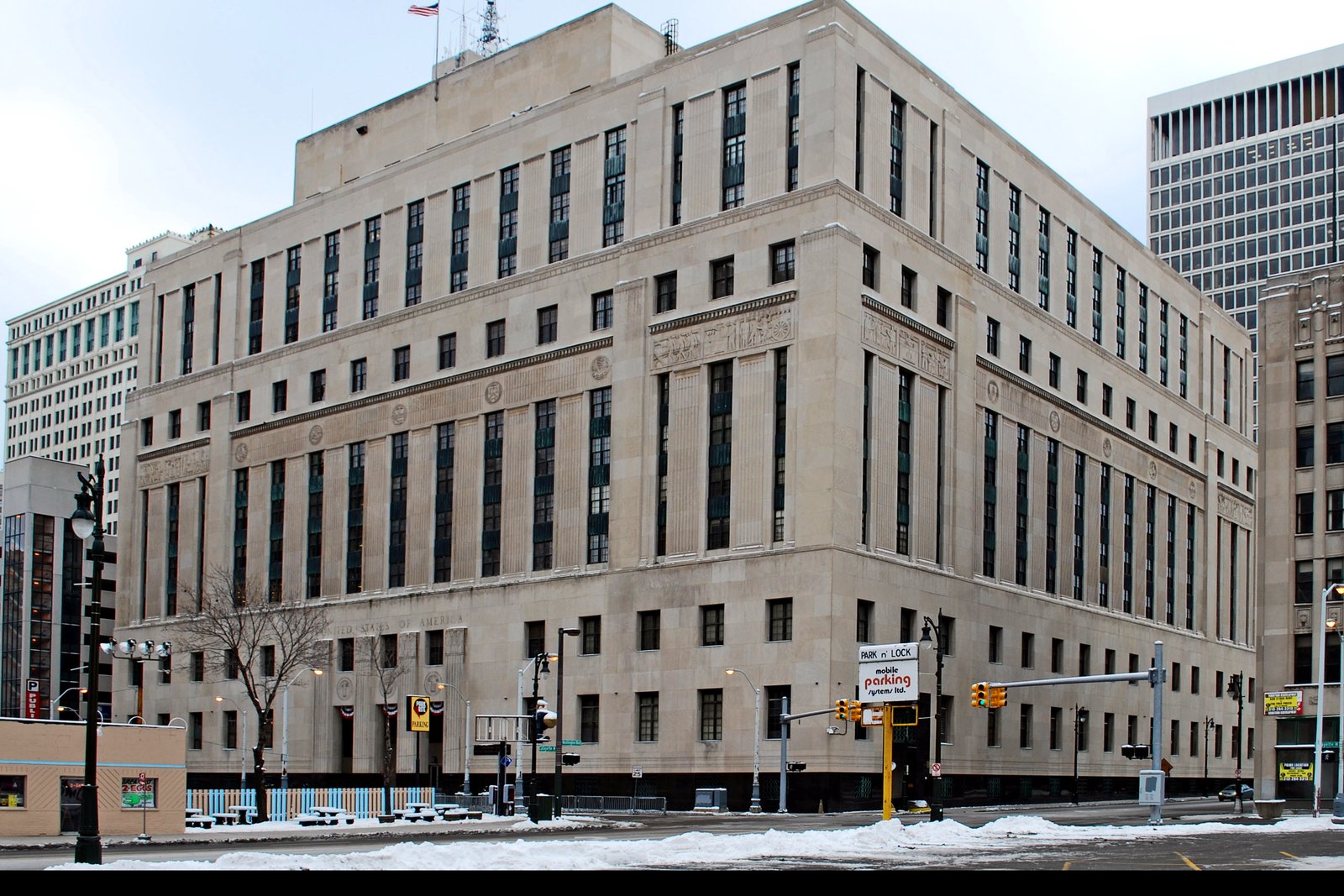 The Theodore Levin United States Courthouse in downtown Detroit, a tall stone federal building seen from the street.