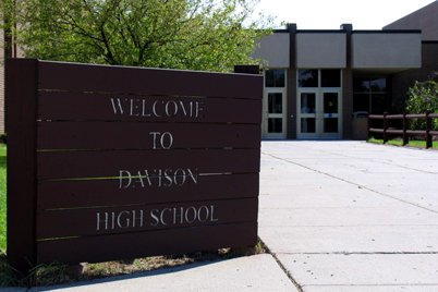 The front entrance of Davison High School in Davison, Michigan, with a brick school building and a Cardinals sign on the lawn, in an August 2006 file photo.