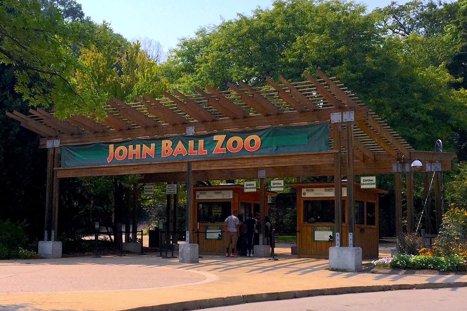 The entrance plaza and signage at John Ball Zoo in Grand Rapids, Michigan, photographed on a sunny day.