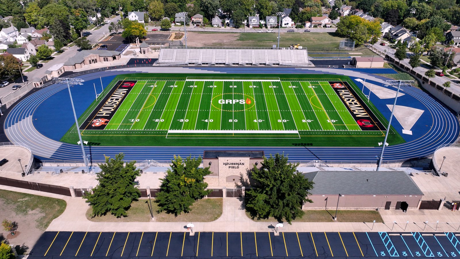 Empty green football field and stands at Houseman Field in Grand Rapids.