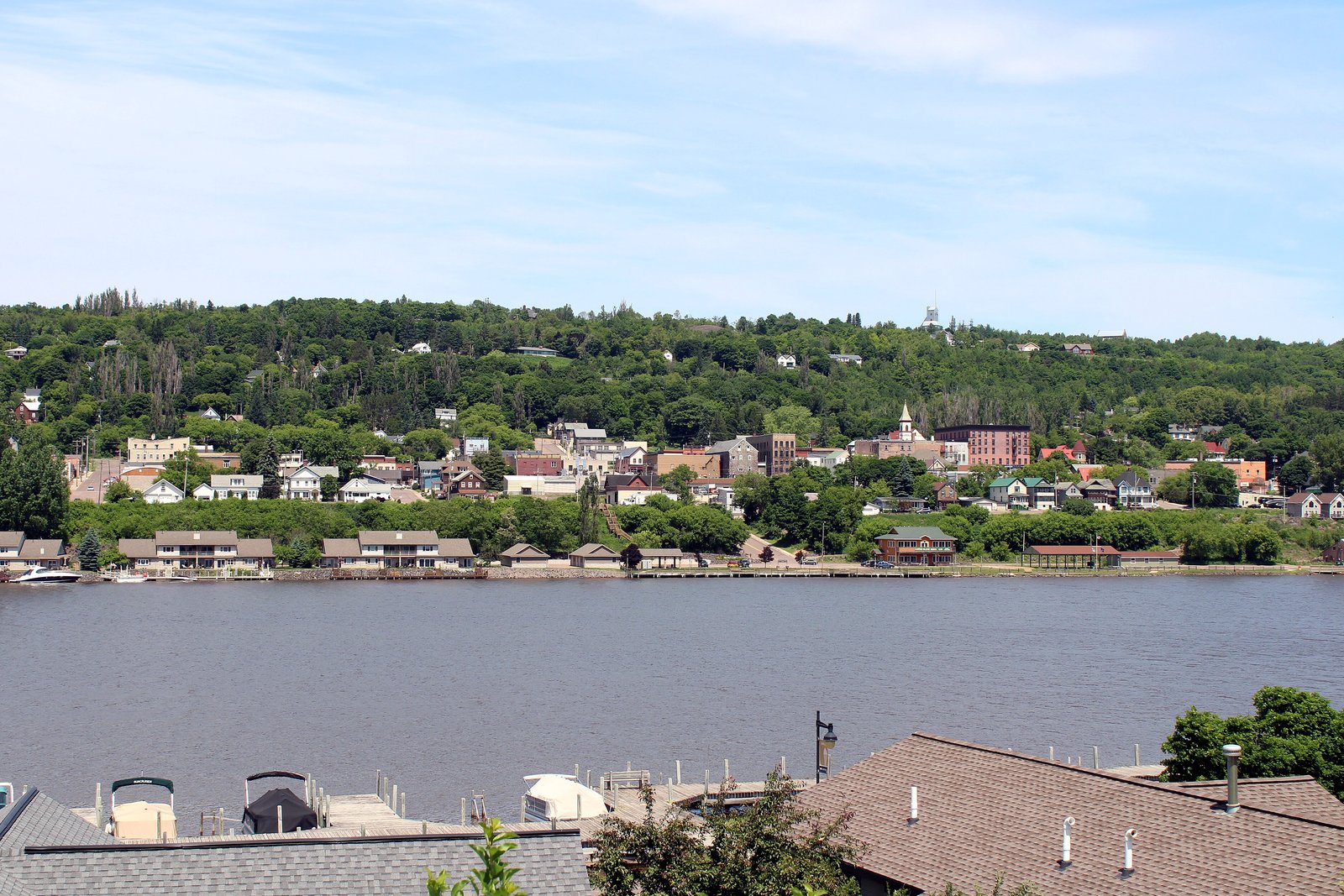 The hillside city of Hancock, with church steeples and houses above the Portage waterway, seen from Houghton.