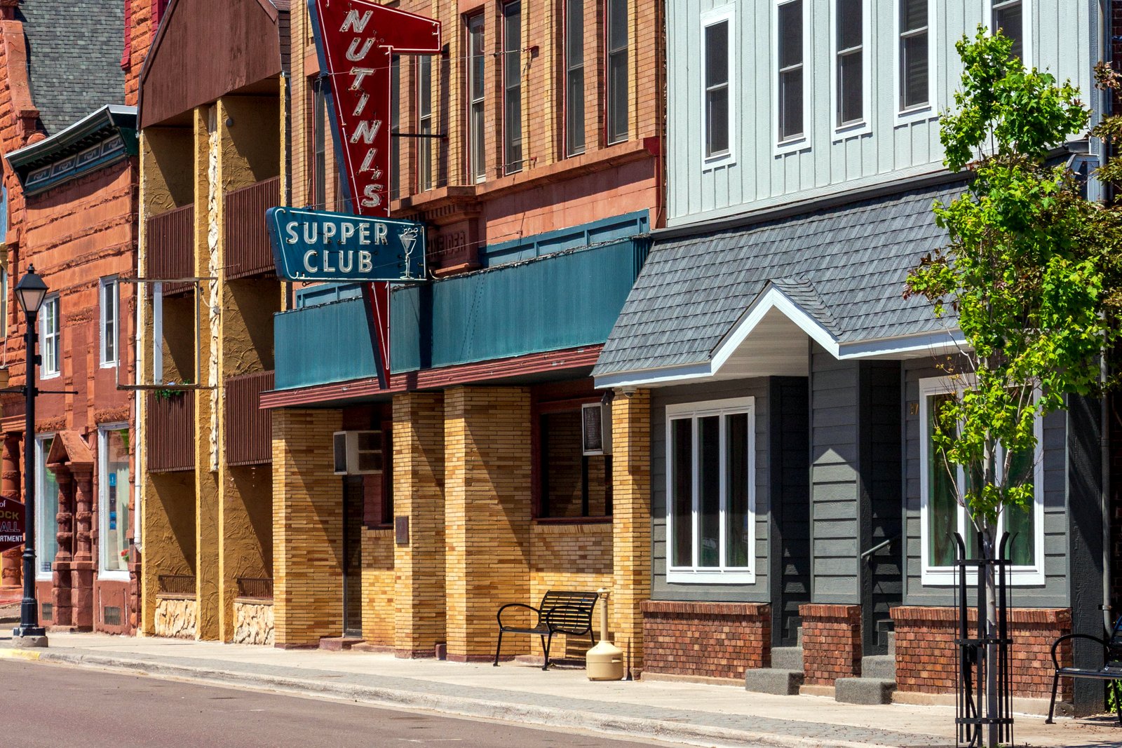 Quincy Street in downtown Hancock, Michigan, lined with brick storefronts on a hillside.
