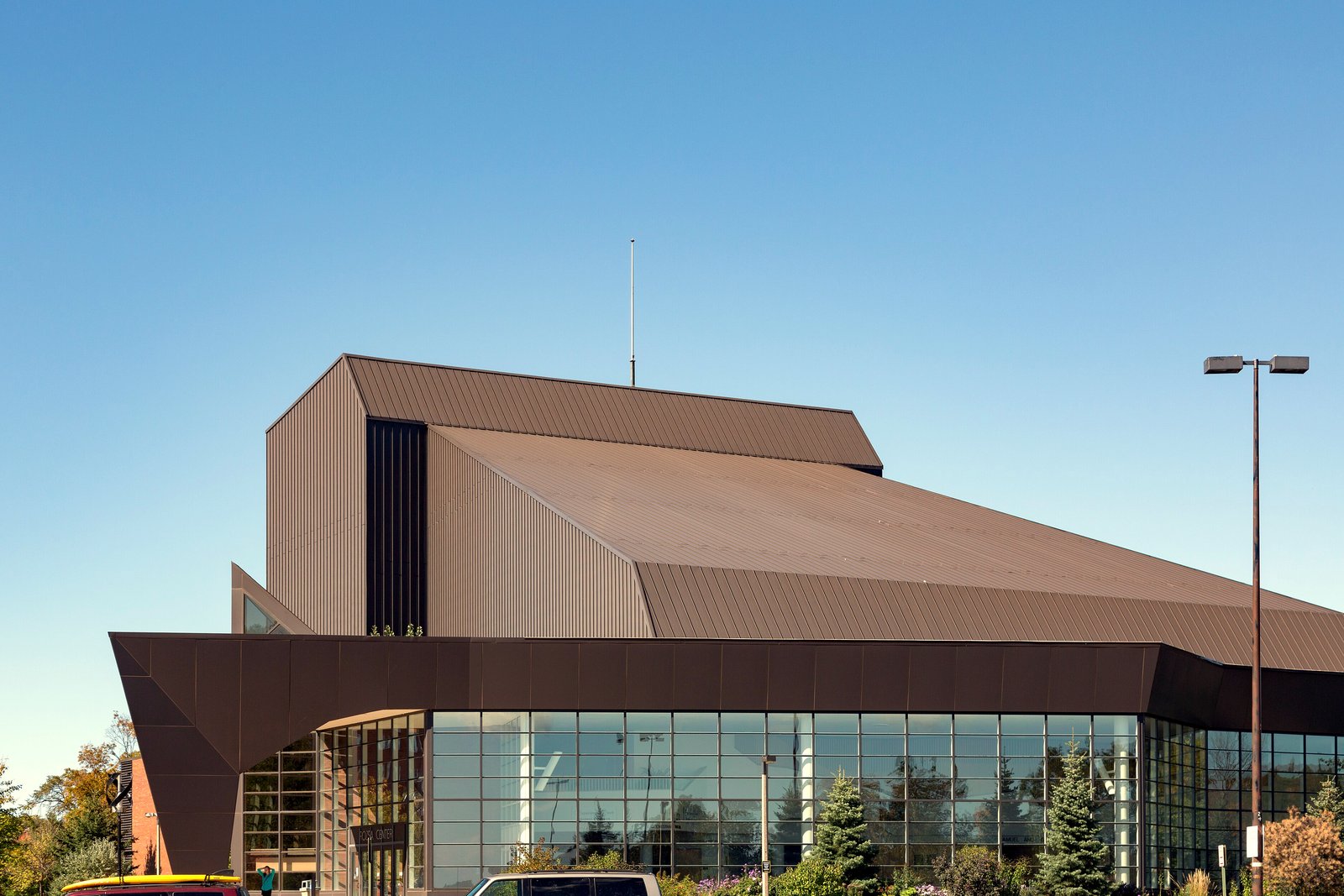 A modern angular performing arts center with metal and glass walls on the Michigan Tech campus.