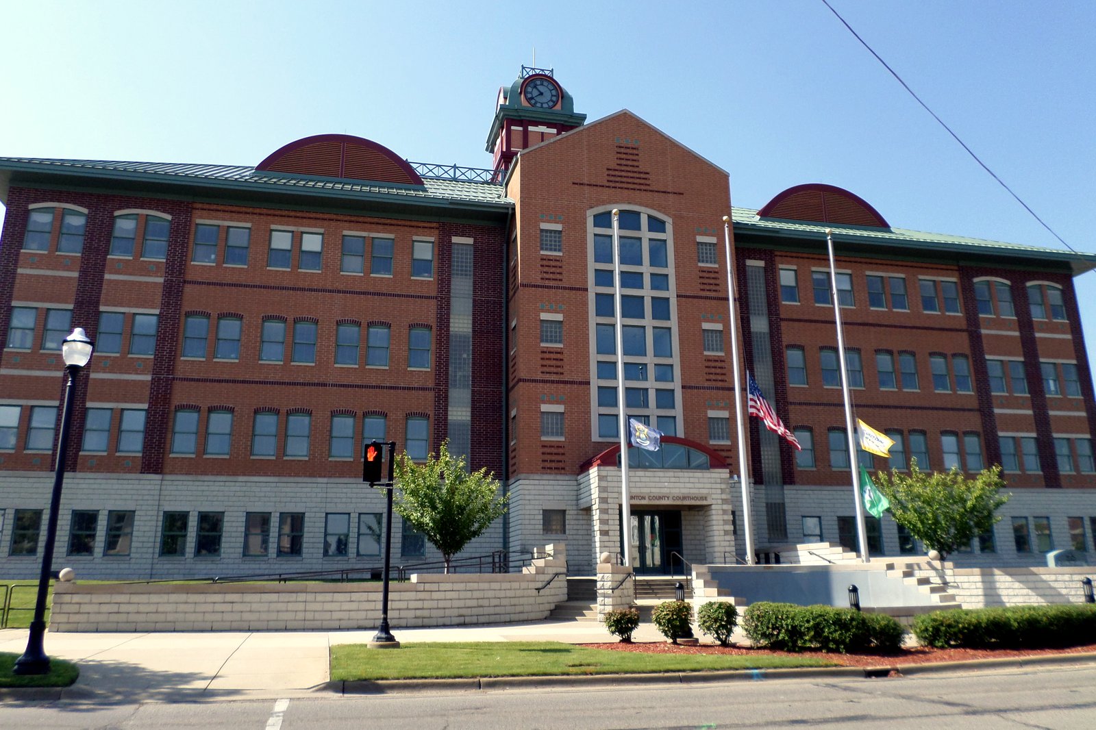 The Clinton County Courthouse in St. Johns, Michigan, a brick and stone building with a clock tower.