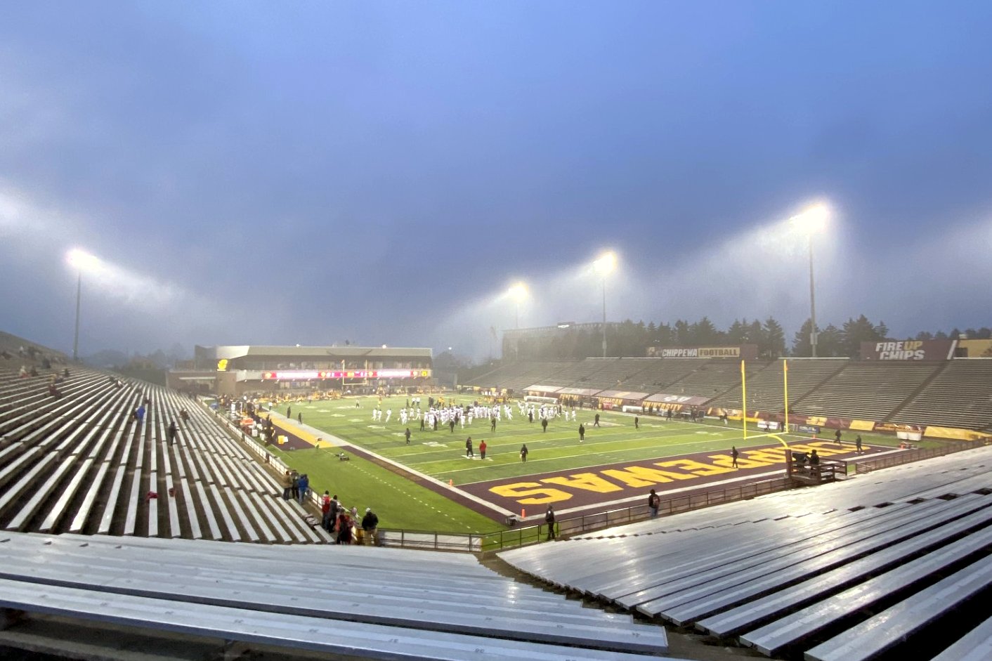 Kelly/Shorts Stadium in Mount Pleasant under stadium lights before a Central Michigan football game, seen from the upper stands.