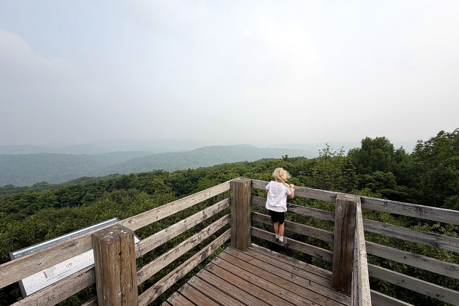Hazy wildfire smoke hangs over a forested ridge and trail at Summit Peak in the Porcupine Mountains, in a file photo from July 2026.