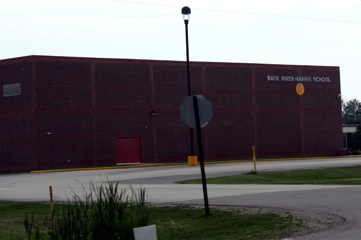 Brick exterior of Bark River-Harris School along U.S. 2/41 in Bark River, with the school name on the wall.