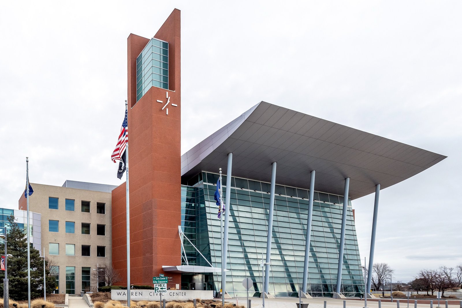 The Warren Civic Center, a modern municipal building with a tall brick tower and glass atrium.
